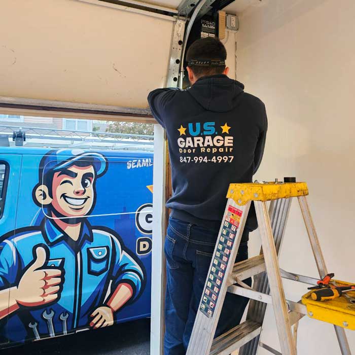 US Garage Door Repair technician fixing a garage door cable near Vernon Hills IL